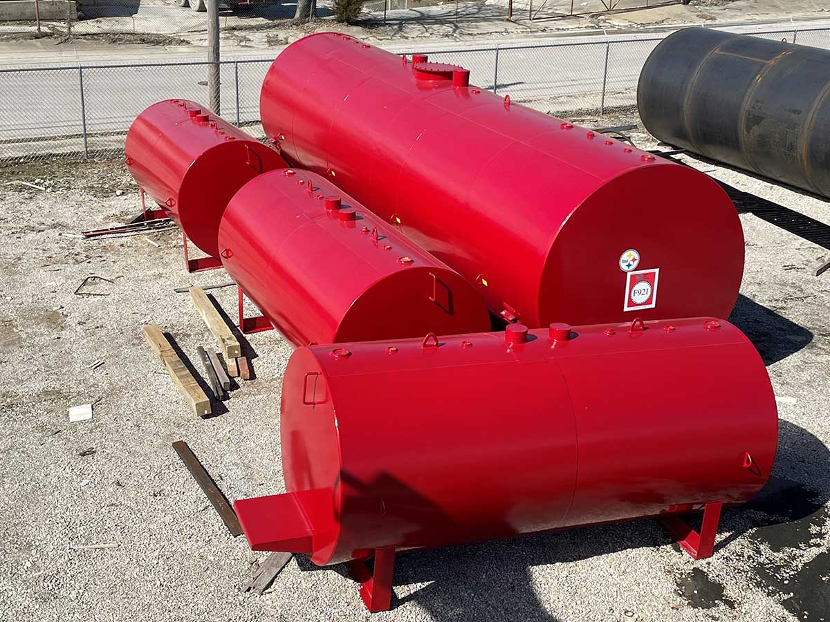 12000 GAL RED F921® DW ON SADDLES; 2000 GAL RED DW TANKS with STEP PLATFORMS AND GRAB HANDLES